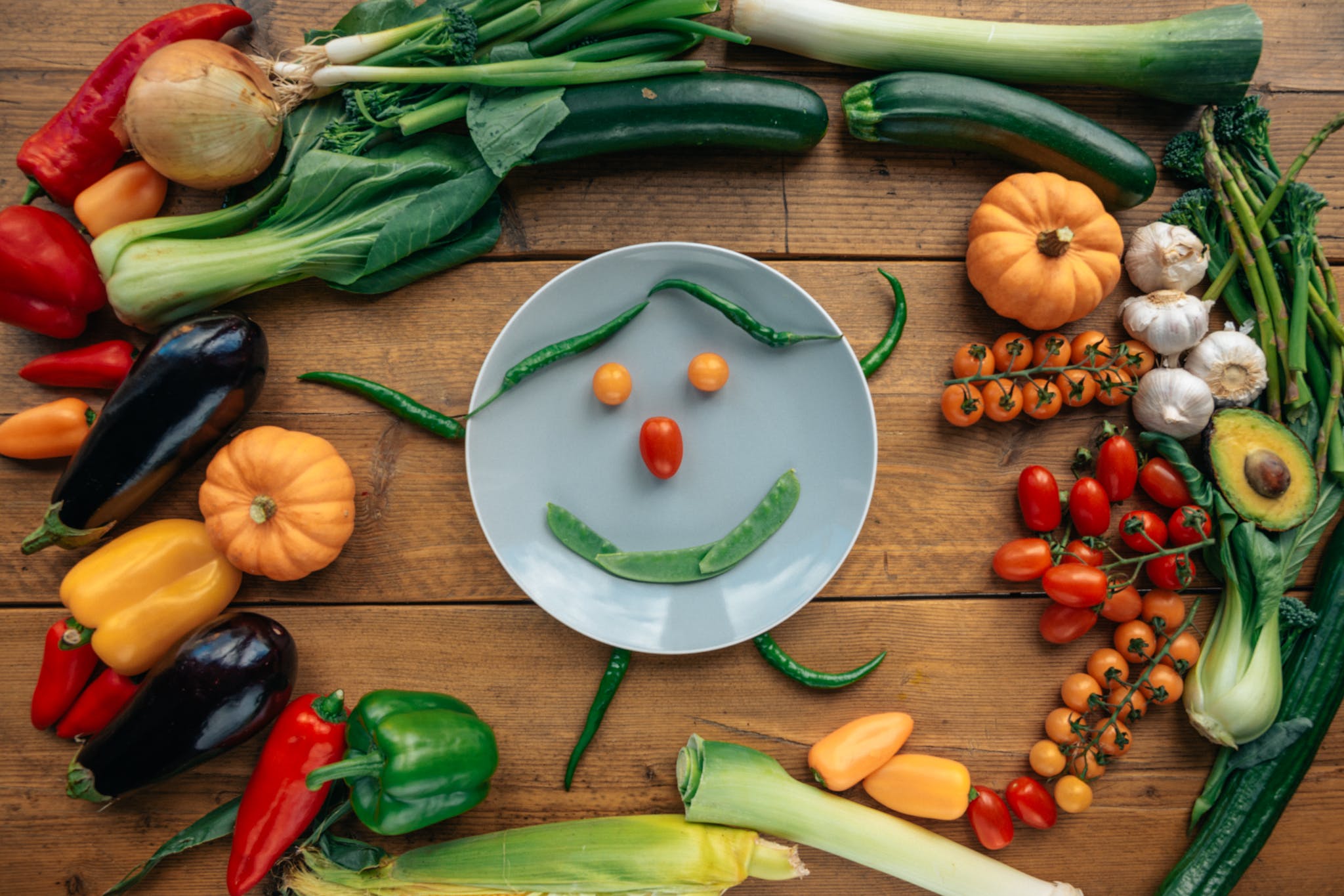 Red Tomato and Green Chili on White Ceramic Plate